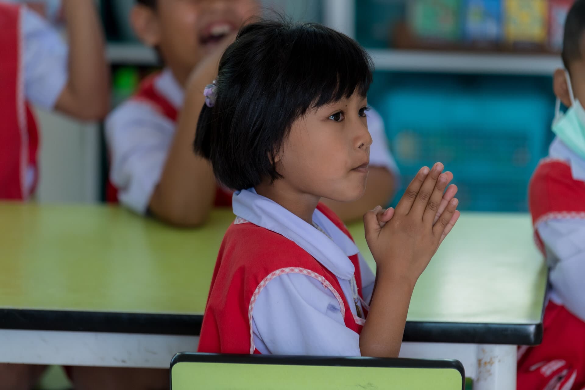 Thai child learning to read in classroom